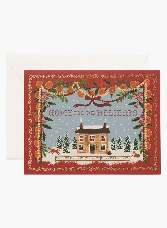 Julkort med hus i snölandskap i dekorativ röd ram och texten Home for the Holidays, med vitt kuvert, från Rifle Paper Co.